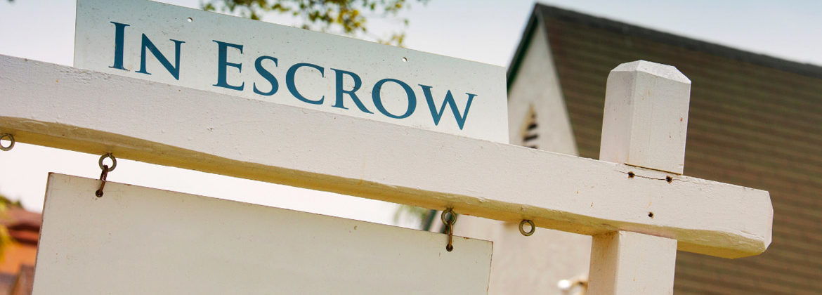 Escrow signage in front yard of house