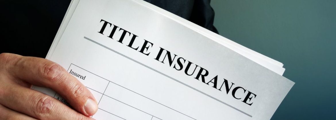 Hand holding title insurance paperwork