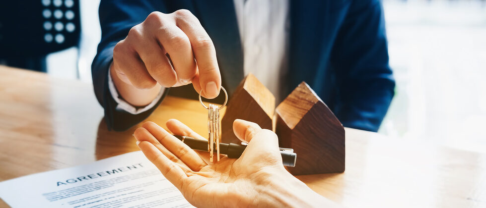 Real estate agents give keys to clients