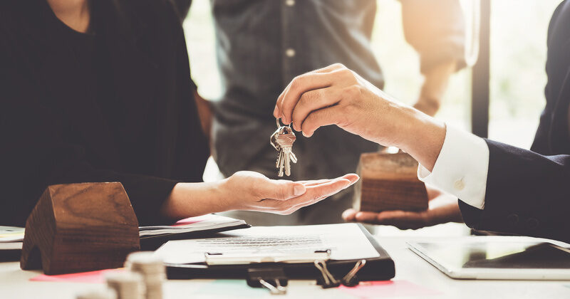 real estate agents are giving house keys of customer